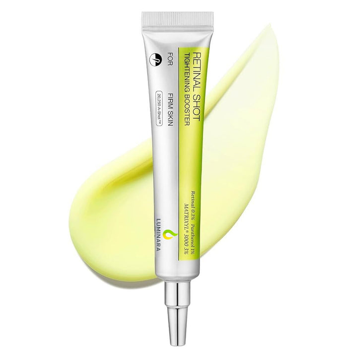 Retinol shot skincare booster with a smear of yellow cream on a white background